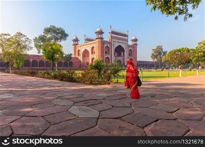 Taj Mahal East Gate and an Indian woman, India, Agra.. Taj Mahal East Gate and an Indian woman, India, Agra