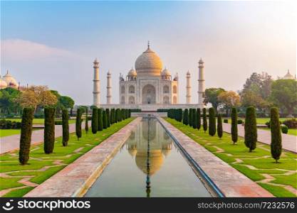 Taj Mahal front view reflected on the reflection pool, an ivory-white marble mausoleum on the south bank of the Yamuna river in Agra, Uttar Pradesh, India. One of the seven wonders of the world.. Taj Mahal front view reflected on the reflection pool.