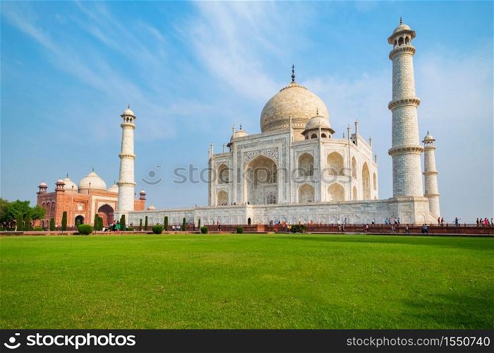 Taj Mahal on a sunny day. An ivory-white marble mausoleum on the south bank of the Yamuna river in Agra, Uttar Pradesh, India. One of the seven wonders of the world.. Taj Mahal on a sunny day.