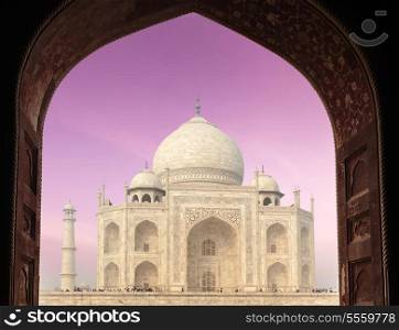Taj Mahal through arch, Indian Symbol - India travel background. Agra, Uttar Pradesh, India