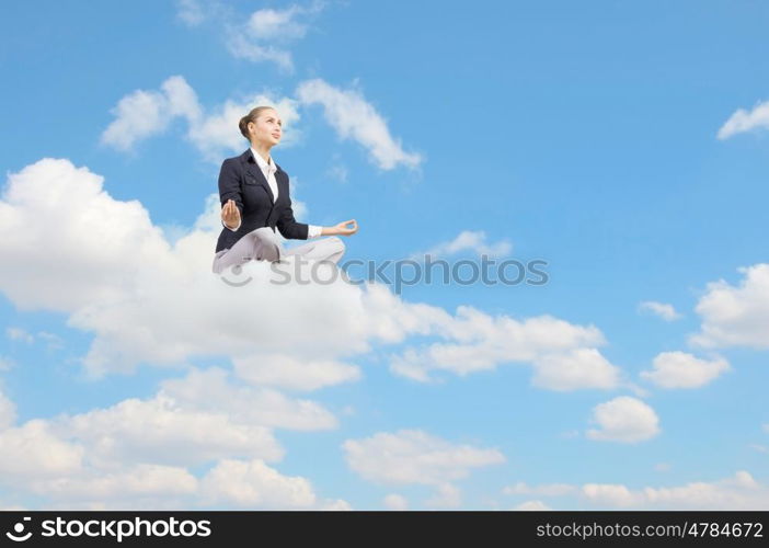 Take a break and relax. Young attractive woman sitting on cloud and meditating