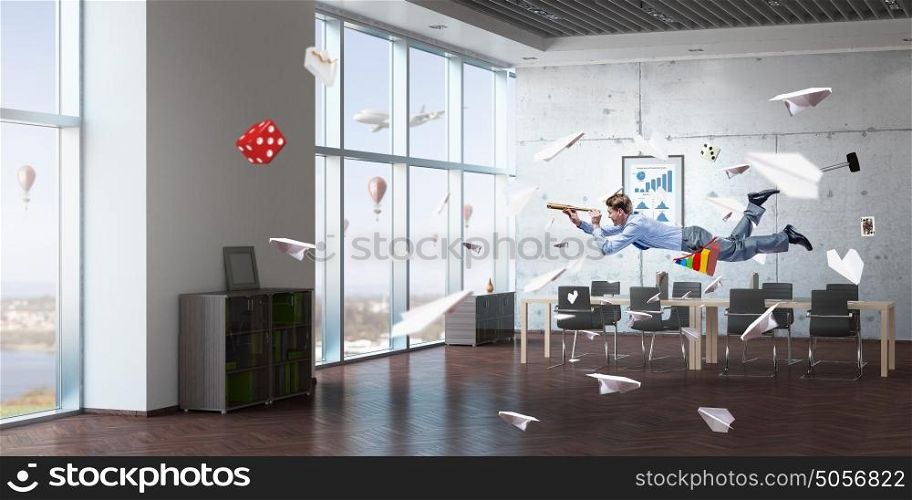 Take a break and relax. Young businessman flying in modern office and looking in spyglass