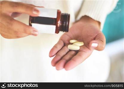Take a medicine health care and people concept / woman holding pill capsule and bottle of medicine supplementary food
