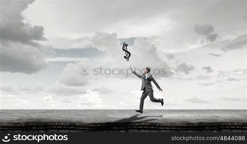 Take a short break. Emotional businessman running and trying to catch color balloon