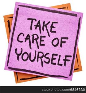 Take care of yourself reminder handwriting on an isolated sticky note