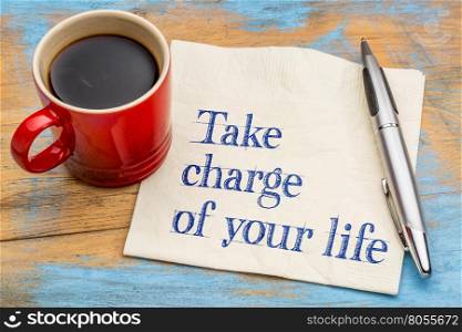 Take charge of your life - handwriting on a napkin with a cup of espresso coffee