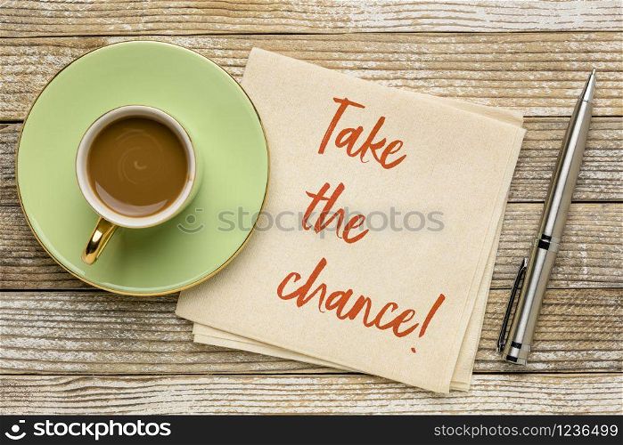 take the chance reminder note - motivational handwriting on a napkin with a cup of coffee, business or personal development concept