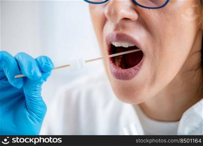 Taking a mouth swab for DNA analysis . Taking a mouth swab for DNA analysis