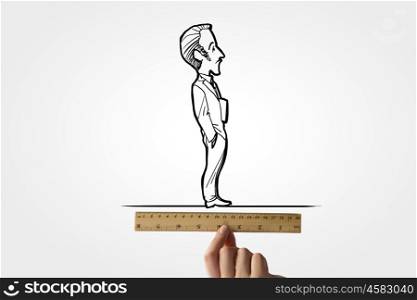 Taking measures. Human hand measuring caricature of businessman with ruler