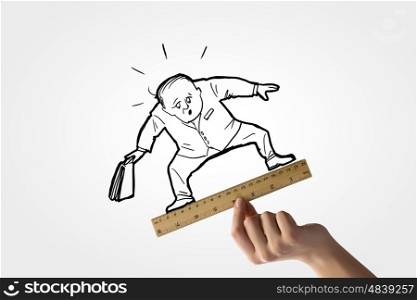 Taking measures. Human hand measuring caricature of businessman with ruler