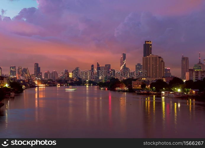 Taksin Bridge with Chao Phraya River, Bangkok Downtown. Thailand. Financial district and business centers in smart urban city. Skyscraper and high-rise buildings with storm rain.