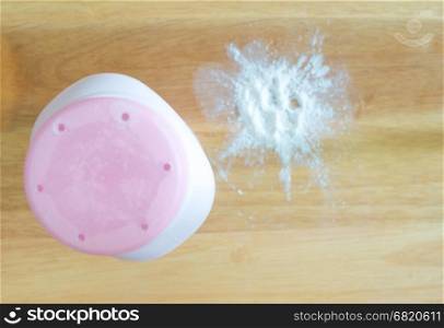Talcum powder on wooden background