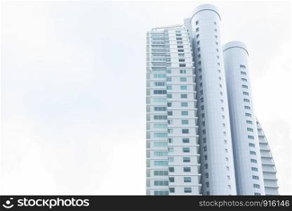 Tall building with clear white sky. Architecture and structure concept. People life and living theme.