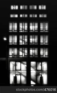 Tall building with lighted windows at night