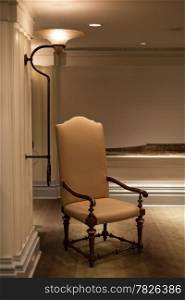 Tall chair. Adjacent to the south wall lamp in the hotel.