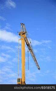 Tall construction crane at a construction site