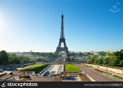 Tall Eiffel tower and park with fountains in Paris