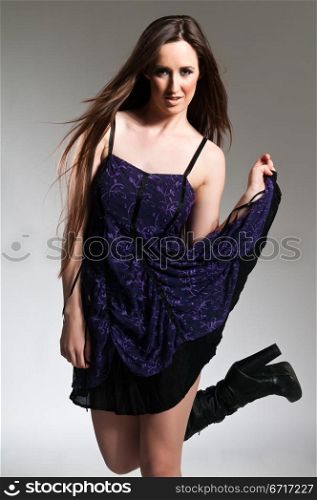 Tall long haired brunette in a purple dress