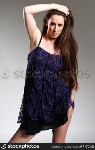Tall long haired brunette in a purple dress