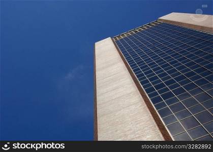 Tall office building with blue sky background.