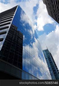 Tall office buildings on sunny day near Whitechapel in London city