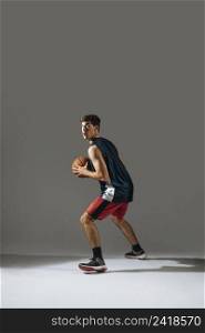 tall young man playing basketball