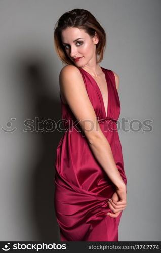 Tall young redhead in a long red dress