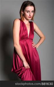 Tall young redhead in a long red dress