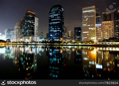 Tallest building in Bangkok, at night. There are various colors of light. Light reflected from the water front.&#xA;