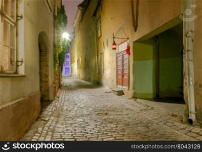 Tallinn. The streets at night.. Old traditional street with a cobblestone street at night. Tallinn. Estonia.