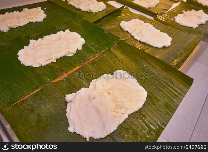 Tamale preparation Mexican recipe with banana leaves and cornmeal