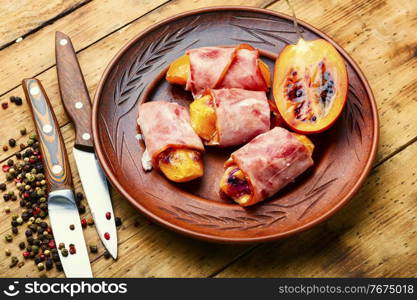 Tamarillo pieces wrapped and baked with ham and bacon. Ham rolls stuffed with tamarillo