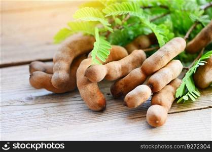 Tamarind sweet for food ripe tamarinds on wooden table, Tamarind tropical fruits summer