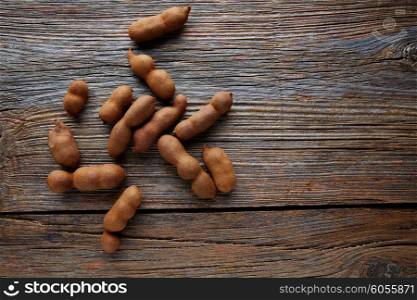 Tamarindo tamarind fruits ripe on brown wood background uses for candy