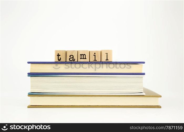 tamil word on wood stamps stack on books, academic and language concept