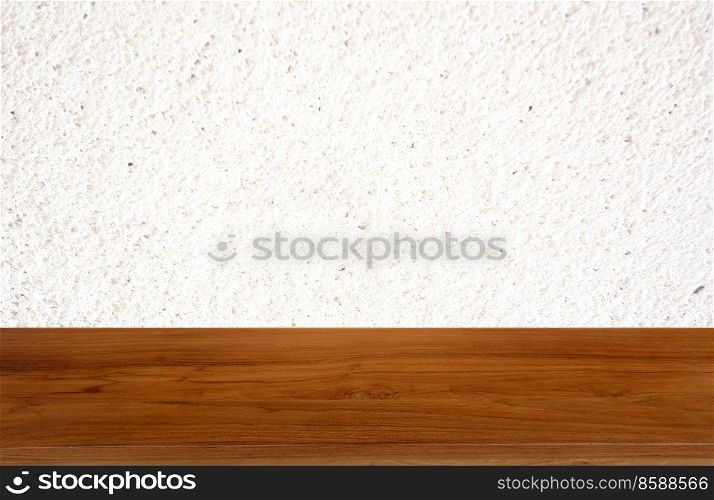 Tan wooden table on white background of cement wall textured- can be used for display or montage your product