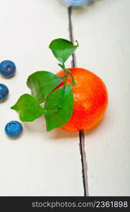 tangerine and blueberry on white rustic wood table