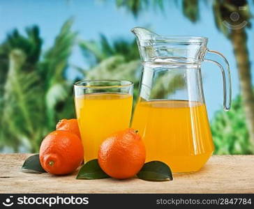 tangerine and juice on a beach table