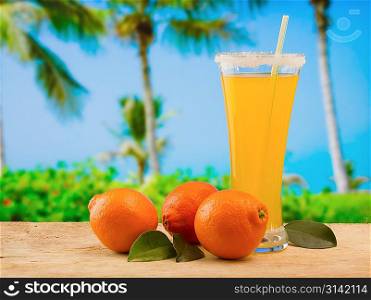 tangerine and juice on a beach table
