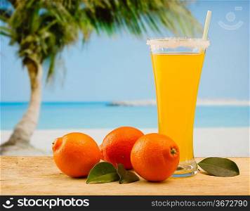 tangerine and juice on a beach table