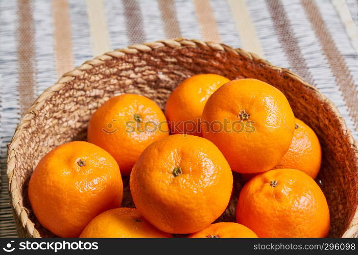 tangerine basket with artisan tablecloth background