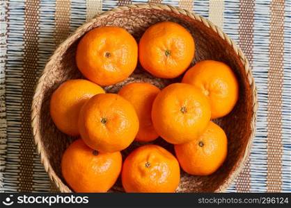 tangerine basket with artisan tablecloth background