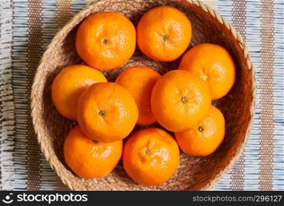 tangerine basket with artisan tablecloth background