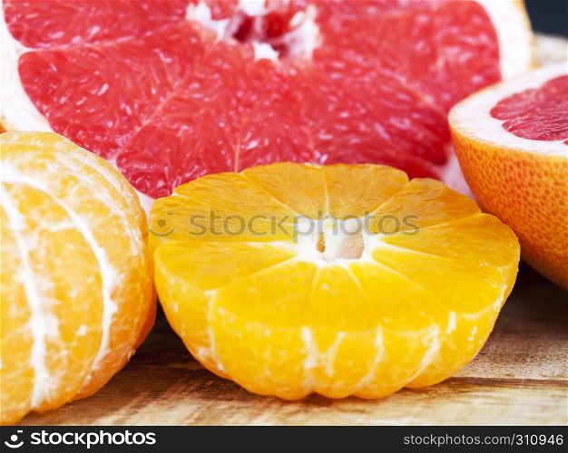 Tangerine oranges and red grapefruit sliced and piled together. tangerine and grapefruit