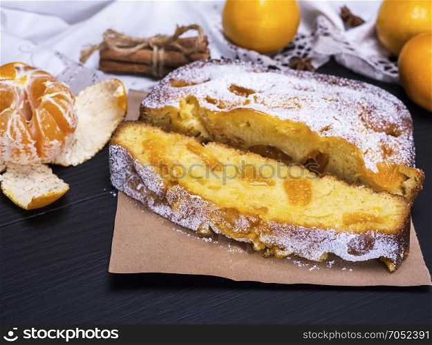 tangerine pie sprinkled with powdered sugar and fresh tangerines