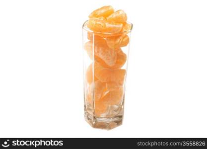 Tangerine segments in a glass on a white background