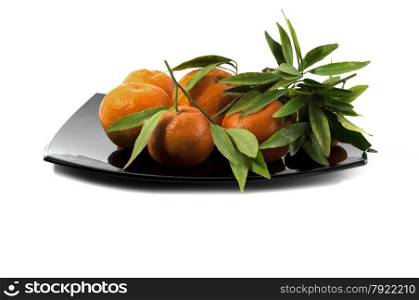 tangerines on a big black plate