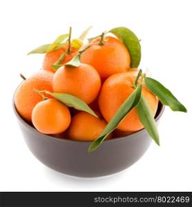 Tangerines on ceramic brown bowl isolated on white background