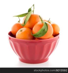 Tangerines on ceramic red bowl isolated on white background