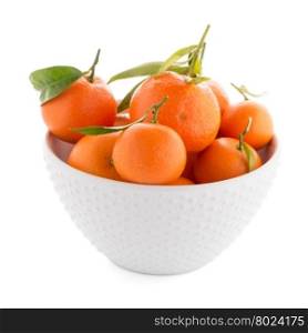 Tangerines on ceramic white bowl isolated on white background